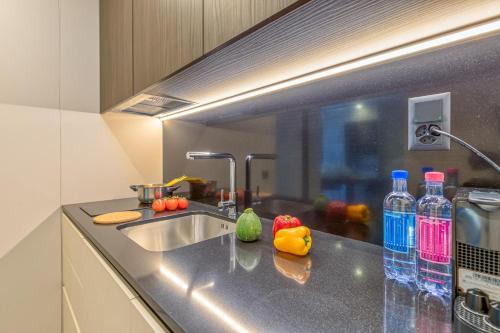 a kitchen with a sink and some bottles of water at ICON H Lugano - Luxury Suites & Apartments in Lugano