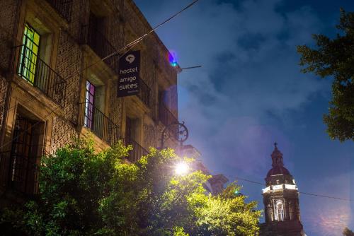 a building with a clock tower at night at Hotel Amigo Suites in Mexico City