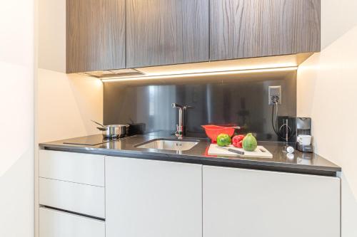 a kitchen with a sink and a counter top at ICON H Lugano - Luxury Suites & Apartments in Lugano