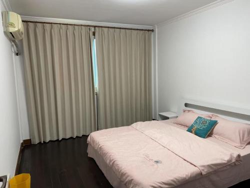 a bedroom with a large bed with a window at Huinan Accommodation, Close to Airport, Disney Resort, Wild Animal Park, Near Metrol 16 in Shanghai
