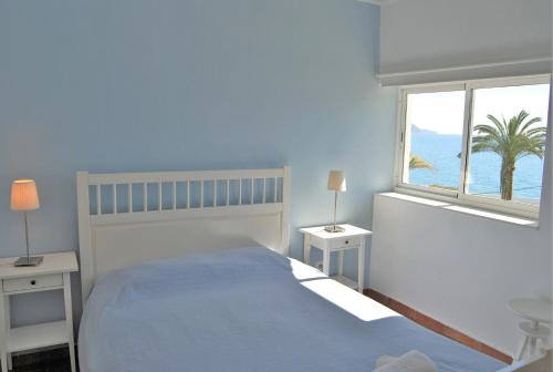 a bedroom with a bed with a view of the ocean at Carabeo 24 Apartments Casasol in Nerja