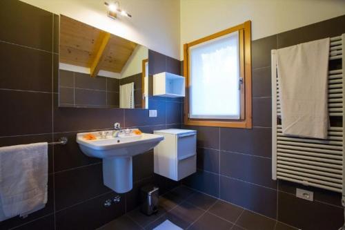 a bathroom with a sink and a toilet and a window at house with 3 bedrooms T5 in Bellano