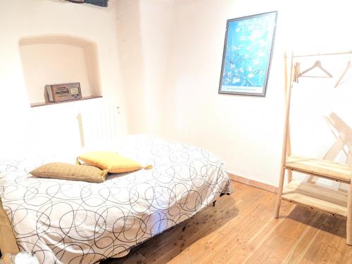a bedroom with a bed and a chair at Gite en Cévennes avec piscine Intérieure chauffée in Ponteils-et-Brésis