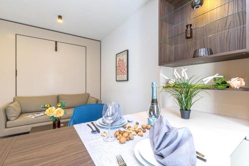 a dining room with a table and a couch at ICON H Lugano - Luxury Suites & Apartments in Lugano