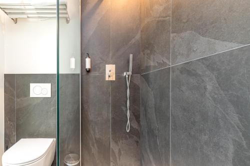 a bathroom with a glass shower with a toilet at ICON H Lugano - Luxury Suites & Apartments in Lugano