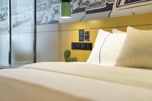 a bedroom with a bed and a cactus at Chongqing North City Sky Hotel in Renhe