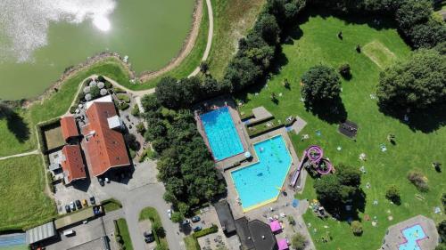 an overhead view of a swimming pool in a park at Luxe Chalet met Veranda en Tuin , nabij Zwembad VP006 in Heinkensand
