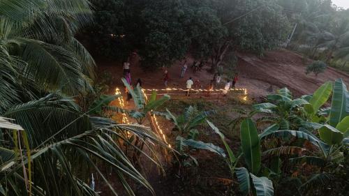 a group of people standing in a field with lights at Healing Home And Hostel Auroville in Puducherry