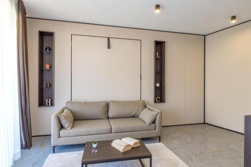 a living room with a couch and a table at ICON H Lugano - Luxury Suites & Apartments in Lugano