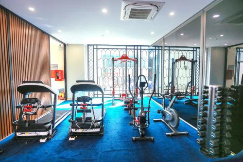 a gym with several treadms and cardio machines at Sandals Vista Hotel in Bao Loc
