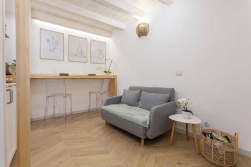 a living room with a couch and a table at Loft La Torre in Cagliari