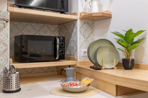a kitchen with a microwave and a bowl of food at Loft La Torre in Cagliari