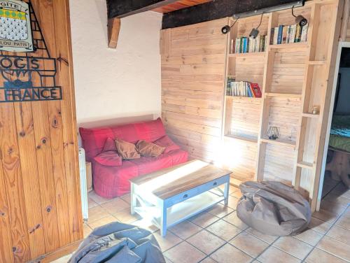 a living room with a red couch in a room at Gite en Cévennes avec piscine Intérieure chauffée in Ponteils-et-Brésis