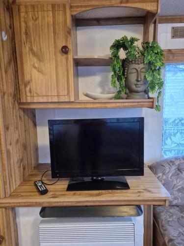 a computer monitor sitting on a desk in a caravan at Mobil-Home N 17 in Fourmies
