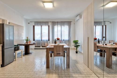 a kitchen and dining room with tables and chairs at Venice Miramare Residence 1 in Zelo