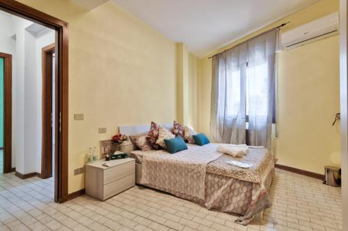 a bedroom with a bed and a large window at Venice Miramare Residence 1 in Zelo