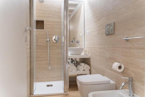 a bathroom with a shower and a toilet and a sink at Loft La Torre in Cagliari