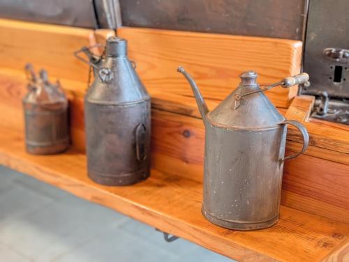 three metal containers sitting on a wooden shelf at Gite en Cévennes avec piscine Intérieure chauffée in Ponteils-et-Brésis