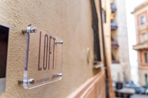 a metal sign on the side of a building at Loft La Torre in Cagliari