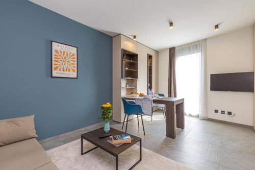 a living room with a table and a blue wall at ICON H Lugano - Luxury Suites & Apartments in Lugano