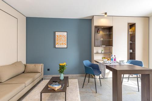 a living room with a couch and a table at ICON H Lugano - Luxury Suites & Apartments in Lugano