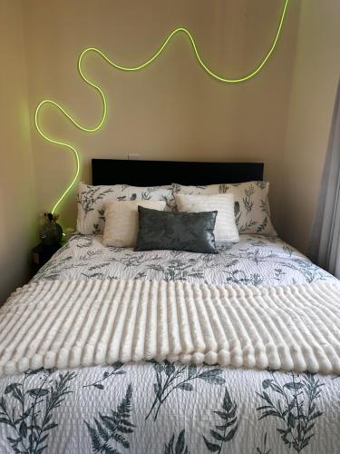 a bedroom with a large bed with a white comforter at City Studio 4 in Coventry
