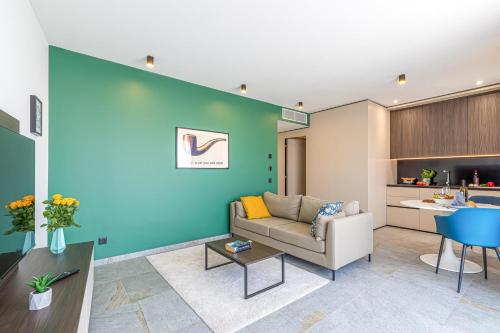a living room with a couch and a blue wall at ICON H Lugano - Luxury Suites & Apartments in Lugano