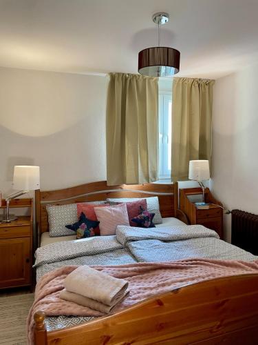 a bedroom with two beds and a window at Urlaub in der Eifel direkt am Rursee - Seeblick in Simmerath