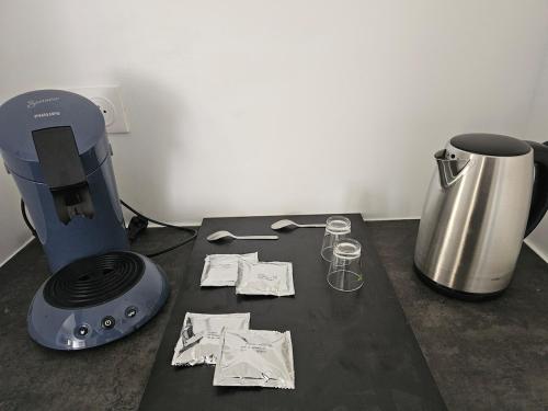 a table with a blender and some papers on it at CosyAppart in Drancy