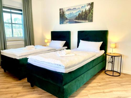 two beds sitting next to each other in a room at Ferienhaus Bayreuth für 10 Personen mit Garten in Bayreuth