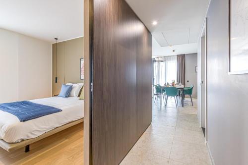 a bedroom with a bed and a dining room at ICON H Lugano - Luxury Suites & Apartments in Lugano
