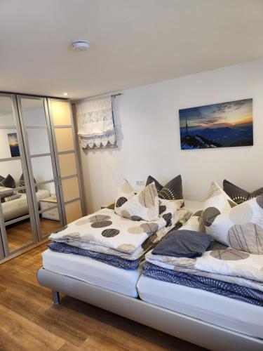 a bedroom with two beds and a mirror at Ferienwohnung Panoramablick in Wertach