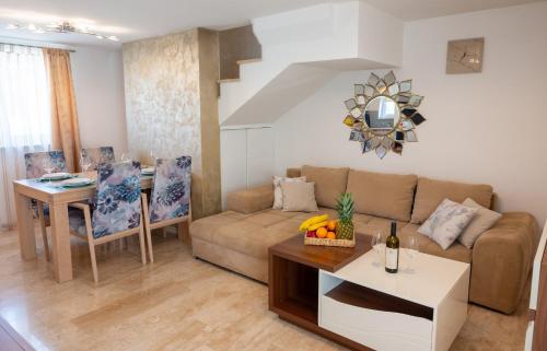 a living room with a couch and a table at Holiday house Lucy in Žgaljić