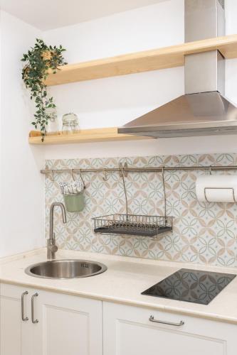 a kitchen with a sink and a counter top at Loft La Torre in Cagliari