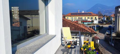 a yellow chair sitting on the balcony of a building at Tominettihome in Verbania