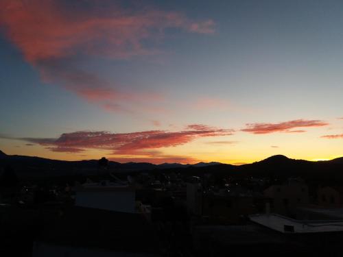 a sunset over a city with mountains in the background at Sivas Apartments-Studios,Sigelakis with very nice view in Sívas