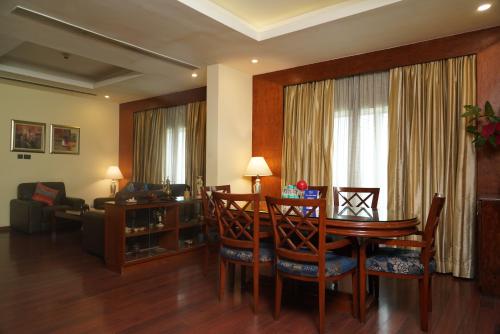 a living room with a table and chairs and a living room at Fortune Select JP Cosmos, Bengaluru - Member ITC Hotels' Group in Bengaluru