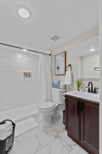 a bathroom with a tub and a toilet and a sink at 4456 Blue Door Bungalow in Southhampton