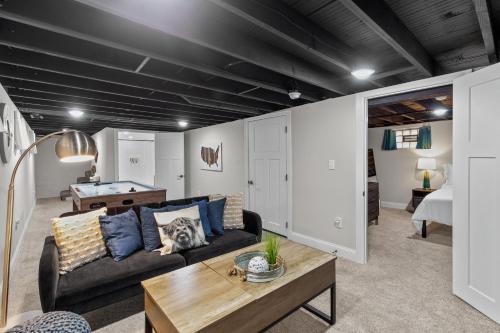 a living room with a couch and a table at 4456 Blue Door Bungalow in Southhampton