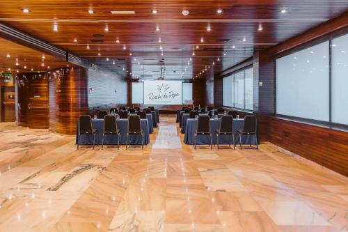 a conference room with chairs and a projector screen at Hotel Murcia Rincón de Pepe Affiliated by Meliá in Murcia