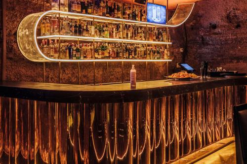 a bar with a bunch of bottles on a wall at Hotel Murcia Rincón de Pepe Affiliated by Meliá in Murcia
