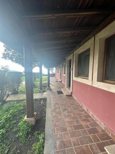 a porch of a building with a brick sidewalk at Hotel Tenuta dell'Argento Resort in Civitavecchia