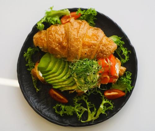 a black plate of food with vegetables on it at Спа-готель ПОЛО-МЕДЛАЙФ in Kremenchuk