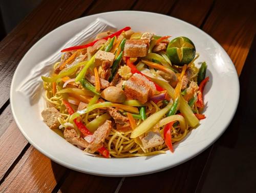 a plate of food with noodles and meat and vegetables at Kayong's Inn in Dumaguete