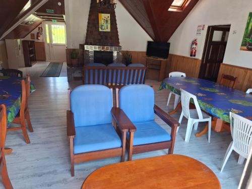 a dining room with tables and chairs and a fireplace at Gite Le Matarum, dortoire familiale 4 personnes in Cilaos