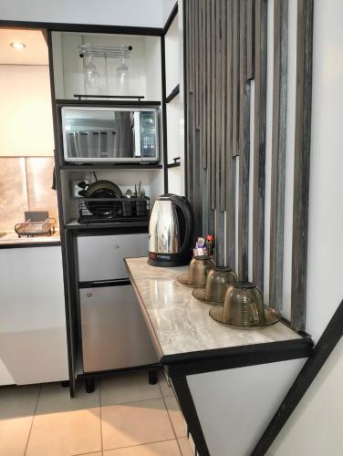 a kitchen with a counter with a microwave and a stove at 20 on Middle in Polokwane