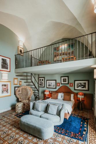 a large bedroom with a bed and a staircase at Palazzo Flora in Gallipoli