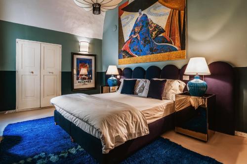 a bedroom with a large bed and a blue rug at Palazzo Flora in Gallipoli