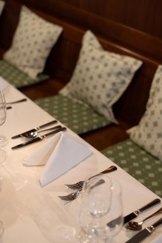 a table with a white table cloth with forks and knives at Hotel Erzherzog Rainer in Vienna