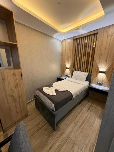 a bedroom with a bed and two lamps and a window at world say hotel in Bostaniçi